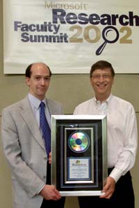         Dr. Andrew Scott (left) of Lancaster University accepts honors from Microsoft's Bill Gates for the British university's research collaboration on the forthcoming new version of Windows CE .NET. 